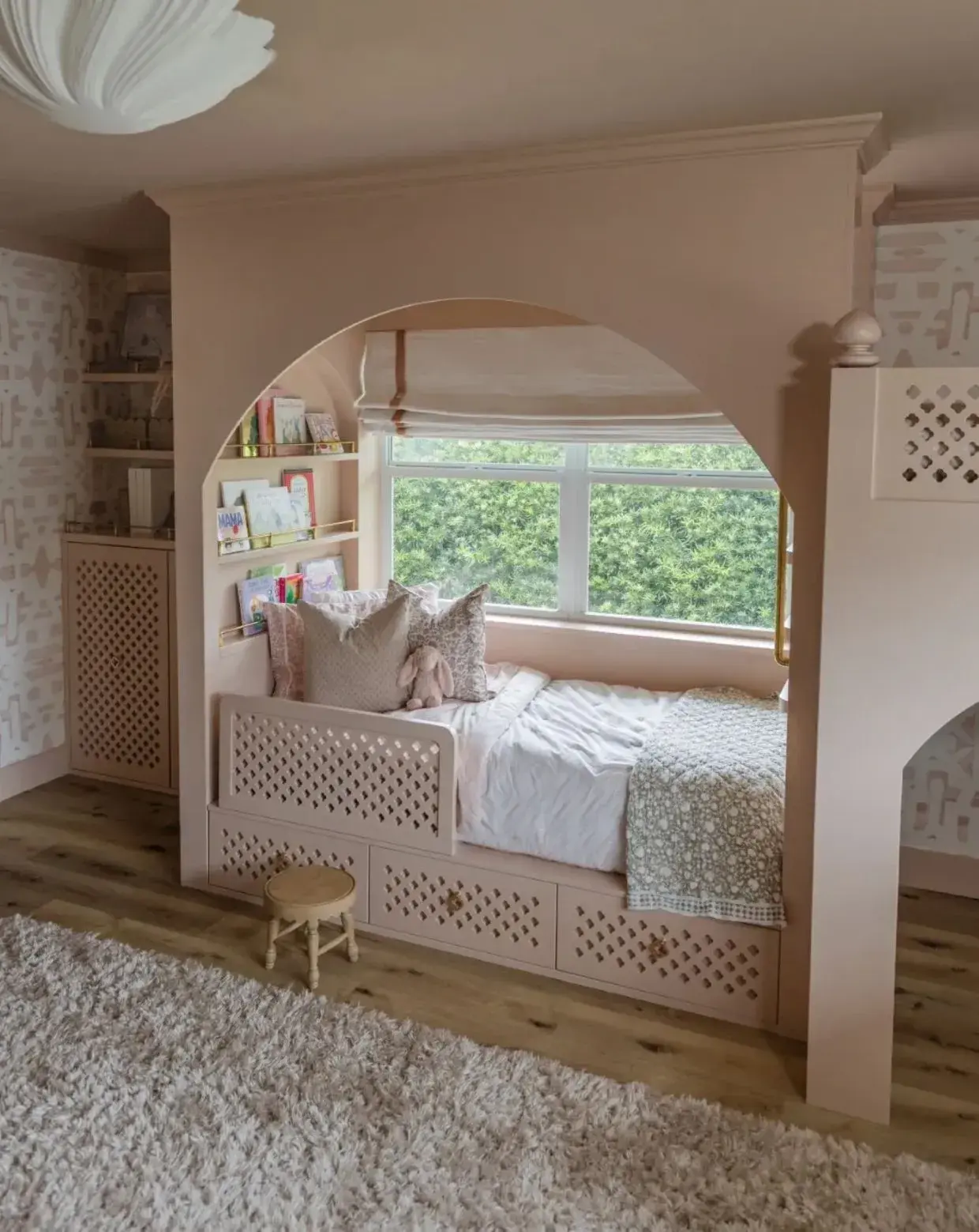 Dusty pink bedroom with storage, bed, and playcastle