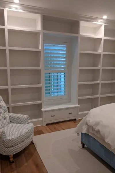 White bookcases with window seat