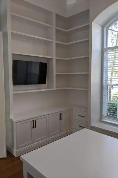 White office cabinetry with TV