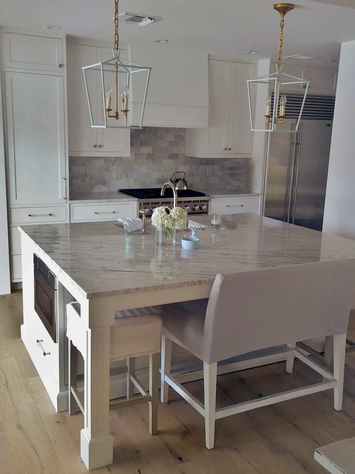 White kitchen with large square island